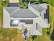 Aerial view highlighting the home's roof with solar panels and a backyard patio at 5226 Nw 21St Loop, Ocala, FL 34482