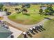 Aerial view of golf course community with palm trees, golf carts, and clubhouse at 5226 Nw 21St Loop, Ocala, FL 34482