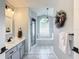 Updated bathroom boasts a soaking tub, walk-in shower, and modern vanity at 5226 Nw 21St Loop, Ocala, FL 34482