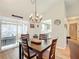 Open dining room with kitchen access, chandelier, and hardwood floors at 5226 Nw 21St Loop, Ocala, FL 34482