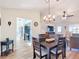 Bright dining room with chandelier and view into kitchen and living room at 5226 Nw 21St Loop, Ocala, FL 34482