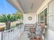 Inviting front porch with rocking chairs and lush tropical plants at 5226 Nw 21St Loop, Ocala, FL 34482