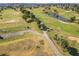 Aerial view of a lush green golf course with palm trees and golf carts at 5226 Nw 21St Loop, Ocala, FL 34482
