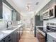 Modern kitchen with gray cabinets, quartz countertops, and stainless steel appliances at 5226 Nw 21St Loop, Ocala, FL 34482