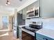 Updated kitchen featuring stainless steel appliances and gray cabinets at 5226 Nw 21St Loop, Ocala, FL 34482