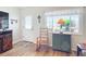 Living room with a rocking chair, hardwood floors, and a view to the front yard at 5226 Nw 21St Loop, Ocala, FL 34482