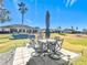 Outdoor patio with table, chairs, and umbrella, perfect for dining al fresco at 5226 Nw 21St Loop, Ocala, FL 34482