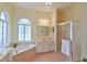 Bathroom with soaking tub, shower, and updated vanity at 5622 Nw 27Th Pl, Ocala, FL 34482