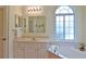 Bathroom with large vanity, soaking tub, and window at 5622 Nw 27Th Pl, Ocala, FL 34482