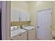 Bright laundry room with washer, dryer, and cabinets at 5622 Nw 27Th Pl, Ocala, FL 34482
