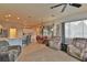 Open living room with seating area, kitchen views, and large windows at 5622 Nw 27Th Pl, Ocala, FL 34482