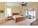 Main bedroom with a king-size bed and access to a lanai at 5622 Nw 27Th Pl, Ocala, FL 34482