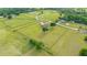 Expansive aerial view of an estate with a pool, home, oversized garage, and manicured lawn at 9901 Nw 6Th Ct, Ocala, FL 34475