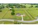 Expansive aerial view of an estate with a pool, home, oversized garage, and manicured lawn at 9901 Nw 6Th Ct, Ocala, FL 34475