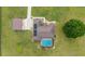 A bird's eye view shows a solar-paneled home with a pool and a large storage outbuilding on green acreage at 9901 Nw 6Th Ct, Ocala, FL 34475