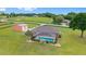 A peaceful, vast, green property boasting a home with a screened pool and a large, versatile outbuilding at 9901 Nw 6Th Ct, Ocala, FL 34475