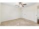 Clean, neutral bedroom with carpet, a ceiling fan, and a single door at 9901 Nw 6Th Ct, Ocala, FL 34475