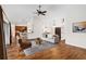 Bright living room with hardwood floors, neutral furniture, and an open floorplan leading to kitchen at 9901 Nw 6Th Ct, Ocala, FL 34475