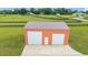 The large, modern barn on the property offers ample storage and workspace, complete with rolling garage doors at 9901 Nw 6Th Ct, Ocala, FL 34475