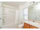 Bright bathroom features a shower-tub combination, single sink vanity, and a window for natural light at 4950 Sw 45Th Cir, Ocala, FL 34474