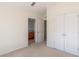 Neutral bedroom featuring double door closet and bathroom access at 4950 Sw 45Th Cir, Ocala, FL 34474