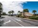 Street view of the community sign amongst lush tropical trees, bushes, and well-maintained landscaping at 4950 Sw 45Th Cir, Ocala, FL 34474