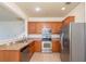 Kitchen featuring stainless steel appliances, light wood cabinets, and tile flooring at 4950 Sw 45Th Cir, Ocala, FL 34474