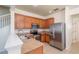 Well-equipped kitchen featuring modern appliances, wooden cabinetry and neutral countertops at 4950 Sw 45Th Cir, Ocala, FL 34474