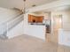 View of an open floor plan from the living room into the kitchen with stairs leading to the upper level at 4950 Sw 45Th Cir, Ocala, FL 34474