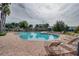 Inviting pool with plenty of lounge chairs, lush palms, and a beautiful view of the apartment buildings at 4950 Sw 45Th Cir, Ocala, FL 34474