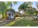 Backyard featuring an outdoor shed and shaded lounging area at 8448 Se 161St St, Summerfield, FL 34491