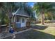 Backyard with storage shed and lush landscaping at 8448 Se 161St St, Summerfield, FL 34491