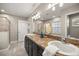 Bathroom featuring dual sinks, dark wood cabinets, and a glass-enclosed shower at 8448 Se 161St St, Summerfield, FL 34491