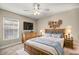 Comfortable bedroom featuring a wooden bed frame, dresser, nightstands, and a ceiling fan at 8448 Se 161St St, Summerfield, FL 34491