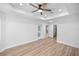 Bright bedroom with ceiling fan and laminate wood floors at 8448 Se 161St St, Summerfield, FL 34491