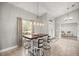 Bright dining area with elegant lighting, adjacent to a window and access to outdoor area at 8448 Se 161St St, Summerfield, FL 34491