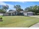 House exterior with driveway and yard at 8448 Se 161St St, Summerfield, FL 34491