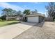 House exterior with driveway, garage, and landscaping at 8448 Se 161St St, Summerfield, FL 34491