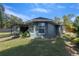 Rear view of house showcasing backyard and landscaping at 8448 Se 161St St, Summerfield, FL 34491