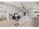 Bright living room with vaulted ceiling, ceiling fan, tile flooring, and sliding glass doors to the outside at 8448 Se 161St St, Summerfield, FL 34491