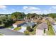 Aerial view of neighborhood showcasing well-maintained homes and lush green landscaping in a desirable community at 9464 Se 132Nd Loop, Summerfield, FL 34491