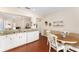 Kitchen featuring granite countertops, white cabinets, open to dining area and a glimpse of the living space at 9464 Se 132Nd Loop, Summerfield, FL 34491