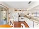 Bright kitchen featuring white cabinetry, granite countertops, stainless steel appliances, and wood flooring at 9464 Se 132Nd Loop, Summerfield, FL 34491