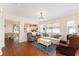 Spacious living room featuring hardwood floors, a chandelier, and ample natural light at 9464 Se 132Nd Loop, Summerfield, FL 34491