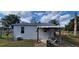 Back of house with covered patio and yard at 10455 Se 108Th Ter Rd, Belleview, FL 34420