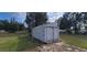 Detached shed in backyard with grassy area at 10455 Se 108Th Ter Rd, Belleview, FL 34420