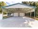 Attached carport with double doors and a large concrete area at 185 Ne 55Th Ave, Ocala, FL 34470