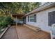 Inviting front porch with built-in bench and wood deck at 4710 Ne 8Th St, Ocala, FL 34470