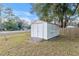 White storage shed in grassy backyard at 8 Pecan Drive Ln, Ocala, FL 34472