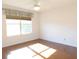 A sun-filled bedroom with hardwood floors and a ceiling fan at 10819 Sw 84Th Ter, Ocala, FL 34481